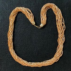 Woman’s beaded gold necklace.